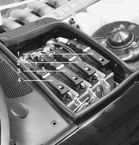 Quickly locate electronic control modules, relays and fuses.
E-box 750iL
E-box 750iL
1. ABS/traction control module
2. DME control module II
3. EML control module
4. DME control module I
5. Hood microswitch
Electrical Component Locations
page 610-7